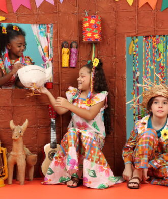 Crianças com trajes e roupas juninas, possivelmente em festa junina infantil comemorando e brincando